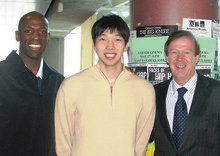 Men’s basketball coach Joe Jones (left) and player K.J. Matsui ’09 with Quigley in Lerner Hall. PHOTO: CHAR SMULLYAN